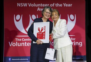 2022 NSW Volunteer of the Year award winner being presented with certificate and trophy