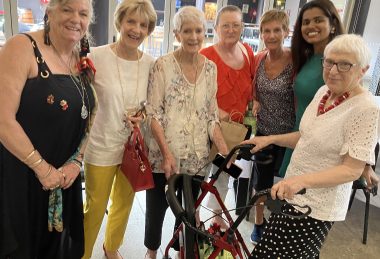 A team of op shop volunteers from the Mid North Coast smile together, on the eve of the biggest volunteer recognition program in the state.