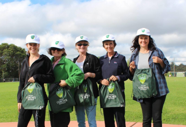 Julie Davis with Blowfly Cricket Volunteers, Holding Coaches Bags